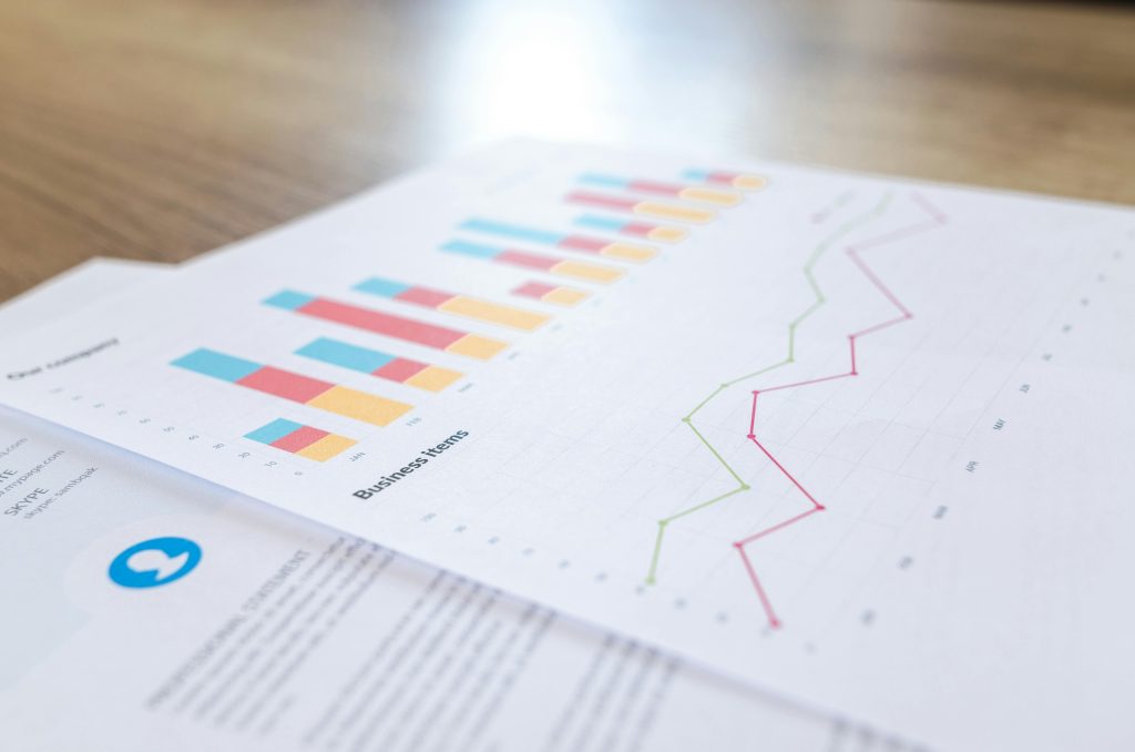 pexels-photo-590045-590045 A close-up view of a business document with charts and graphs on a wooden desk.